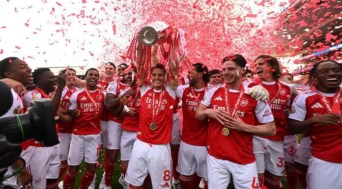 Arsenal players lift the Premier League trophy
